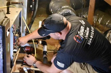 Optimum technician servicing an attic air handler