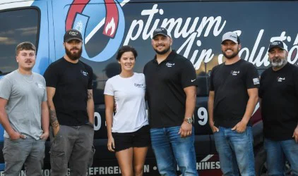 The Optimum Air Solutions team in front of a company van